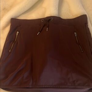 Athleta Burgundy skort with built in mesh shorts and zipper pockets